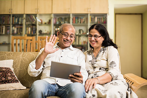 grandparents on a tablet waving 