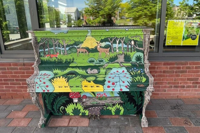 Colourfully painted piano sitting outside the library