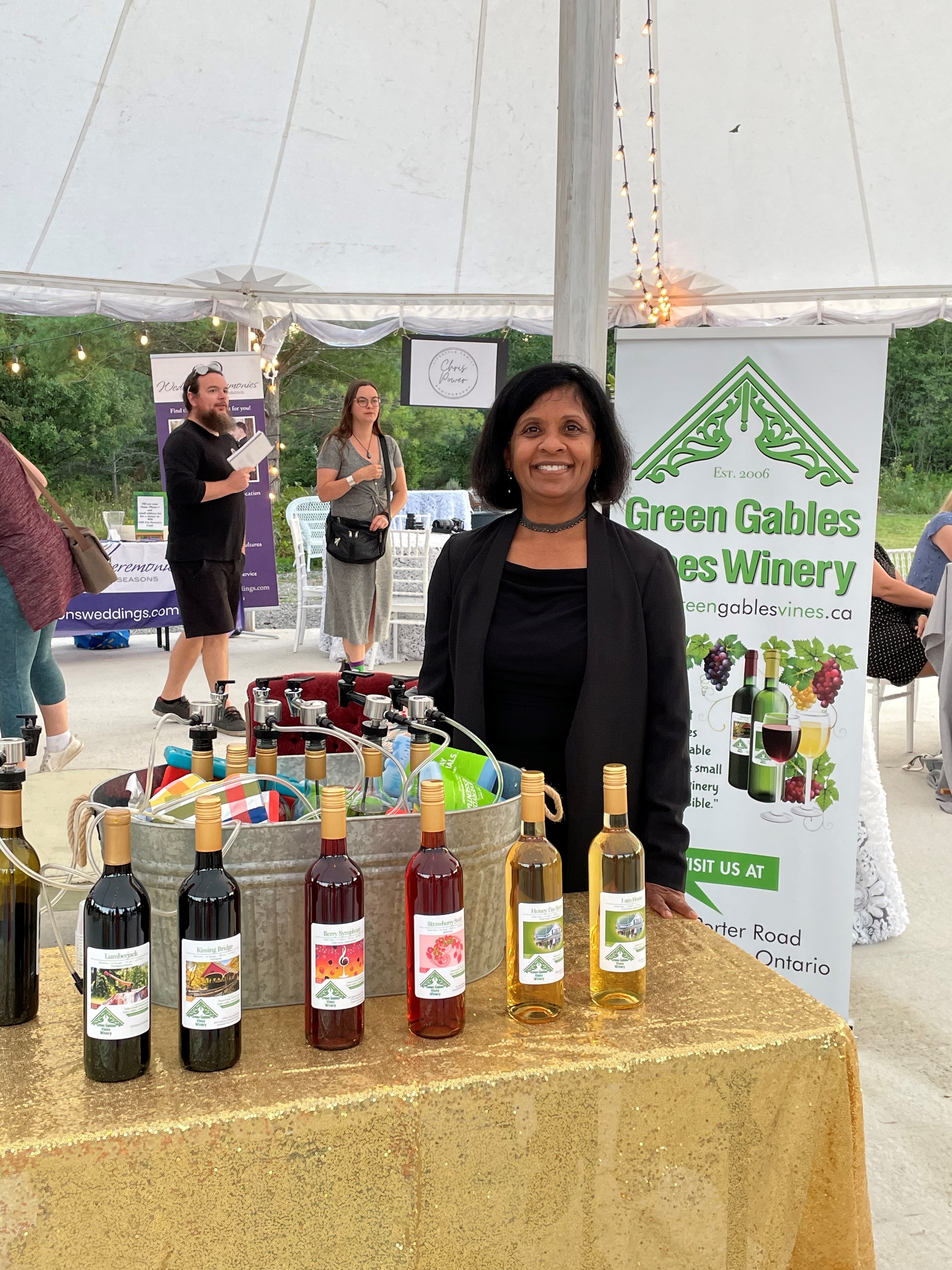 Green Gables Vines winery owner and hostess Marie Chinnatamby displays the wines produced at her winery at a wine show in Merrickville