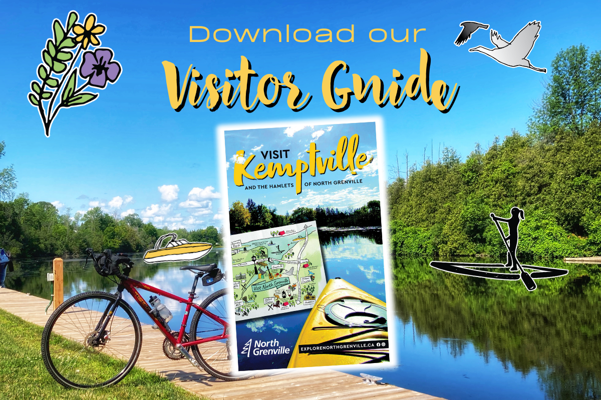 Image of the visitor guide laid on top of a photo of a dock along the river