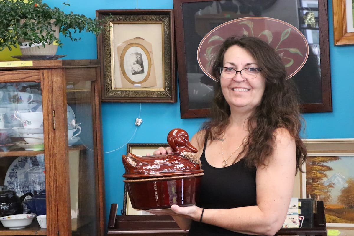 Store owner Susie McIntosh poses with a ceramic duck