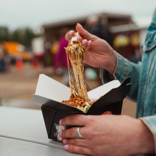 Cheesy poutine from Fat Les's stretching high as the fork lifts the fries